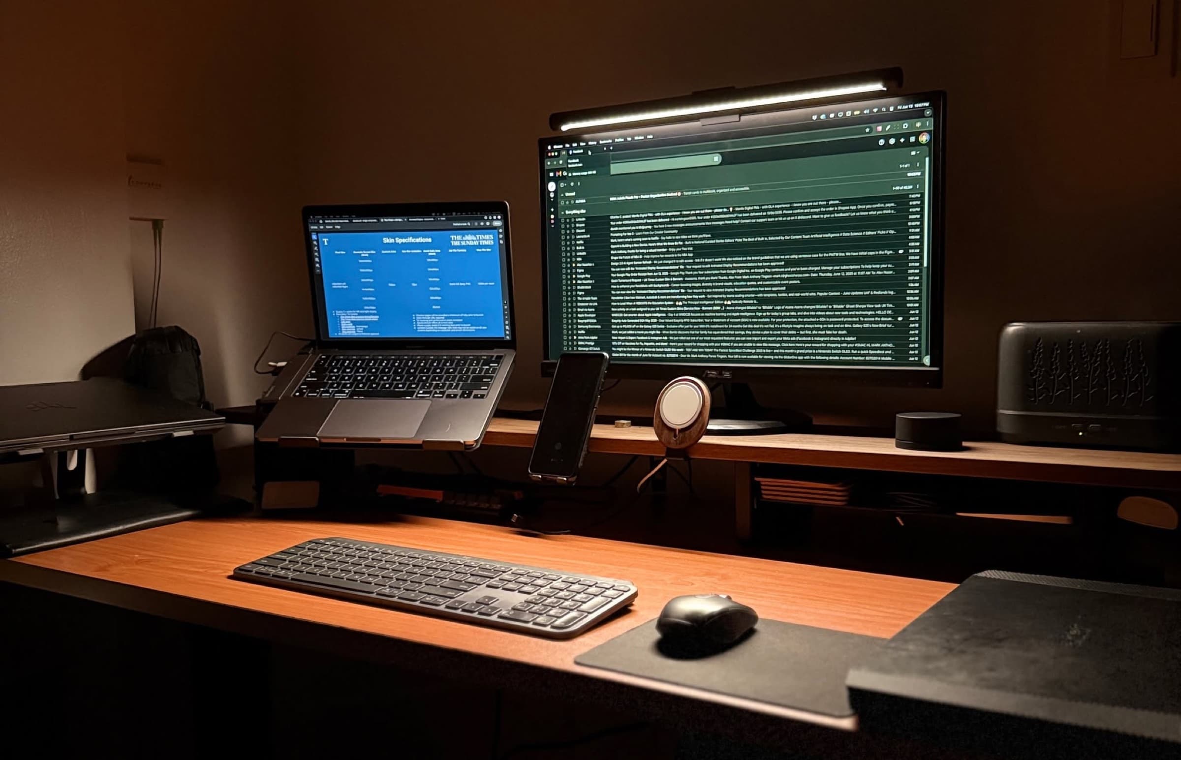 Mark's desk setup: MacBook and monitor under warm lamp light